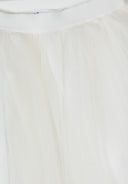 Close-up of off-white pleated tulle fabric with soft, flowing design for girls' fashion skirt.