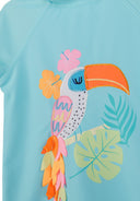 Turquoise kids swimwear top with colorful toucan applique and tropical leaf design, showcasing unique playful style.