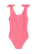 Pink textured girls swimsuit with sleeveless knotted shoulder straps and a simple, elegant design
