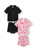 Two girls short sleeve pyjama sets with soft fabric, one solid black and one pink with bow print design.