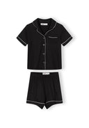 Black short sleeve pajama set with white piping detail and button front, featuring a soft breathable fabric design for kids.