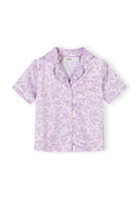 Lilac satin girls' pajama top with white heart print and button front showcasing a unique design.