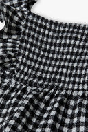 Girls dress check tiered black 3-14y featuring shirred panels and frilled edges in a monochrome black and white check pattern.