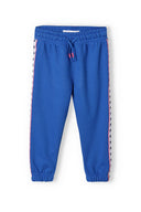 Girls jogpant with side taping blue 3-14y featuring soft fleece fabric, elastic waistband, and stretchy ribbed cuffs.