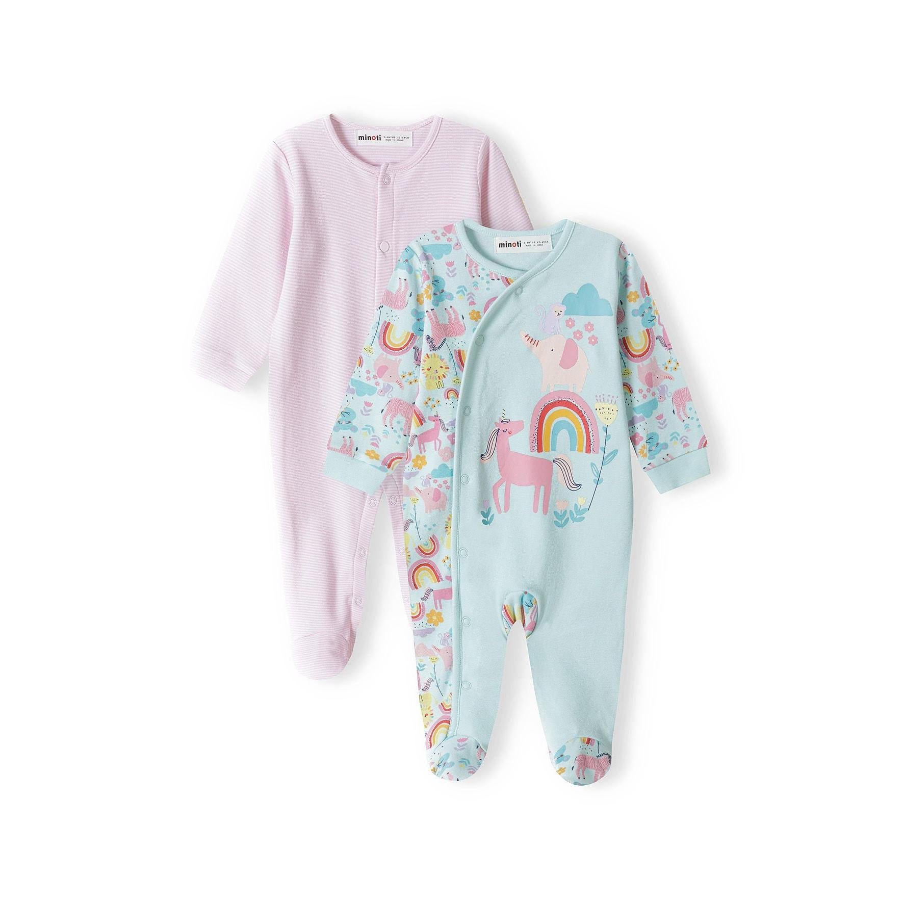 Two baby sleepsuits displayed flat - pink striped sleepsuit on left with button front closure, unicorn rainbow print sleepsuit on right with wrap styling, both with enclosed feet