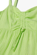 Bright green girls tiered summer dress with ruched chest panel and adjustable ties for ages 3-14y. Enhanced comfort with woven crinkle fabric.