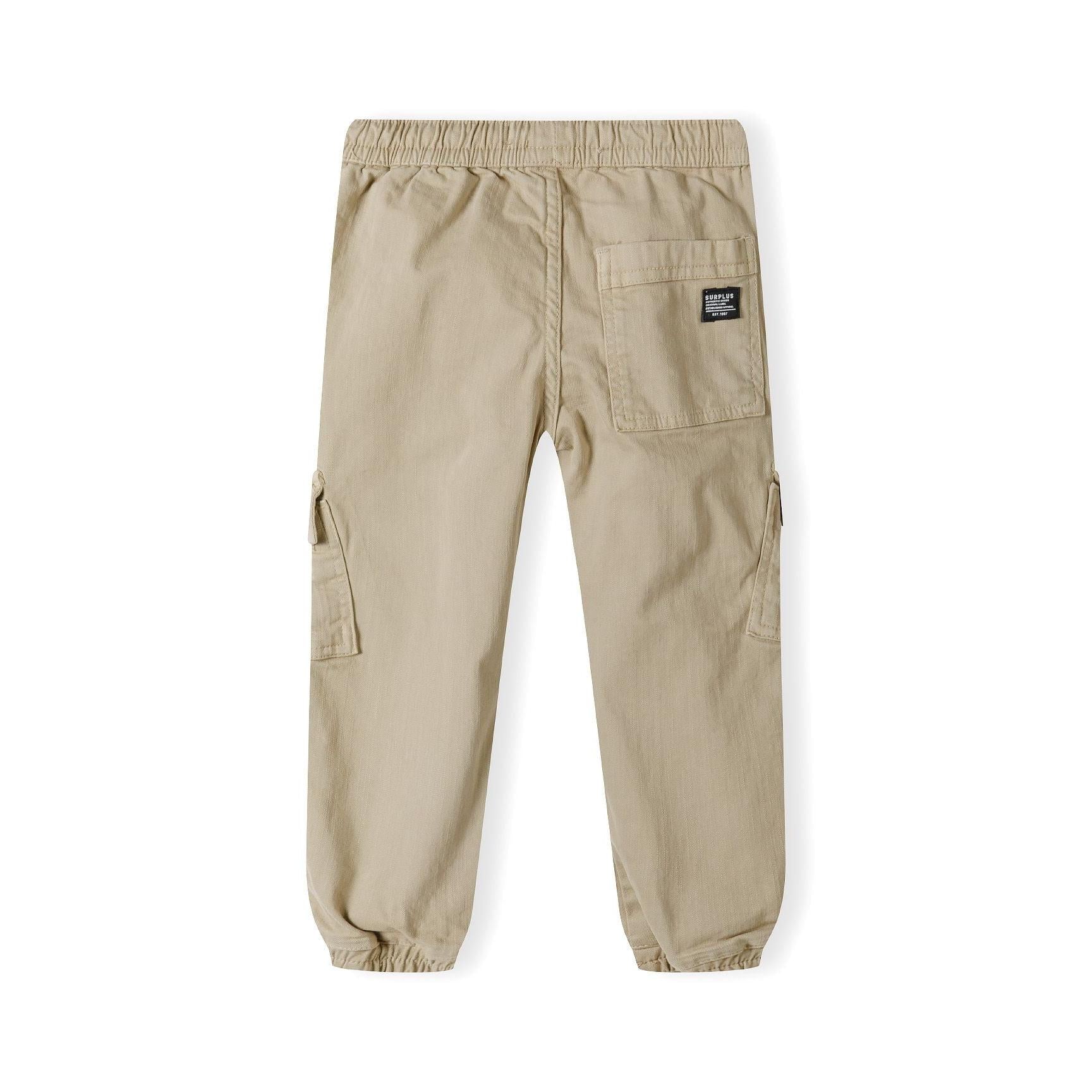 Back view of beige cargo trousers showing rear pocket with black label patch and ribbed ankle cuffs