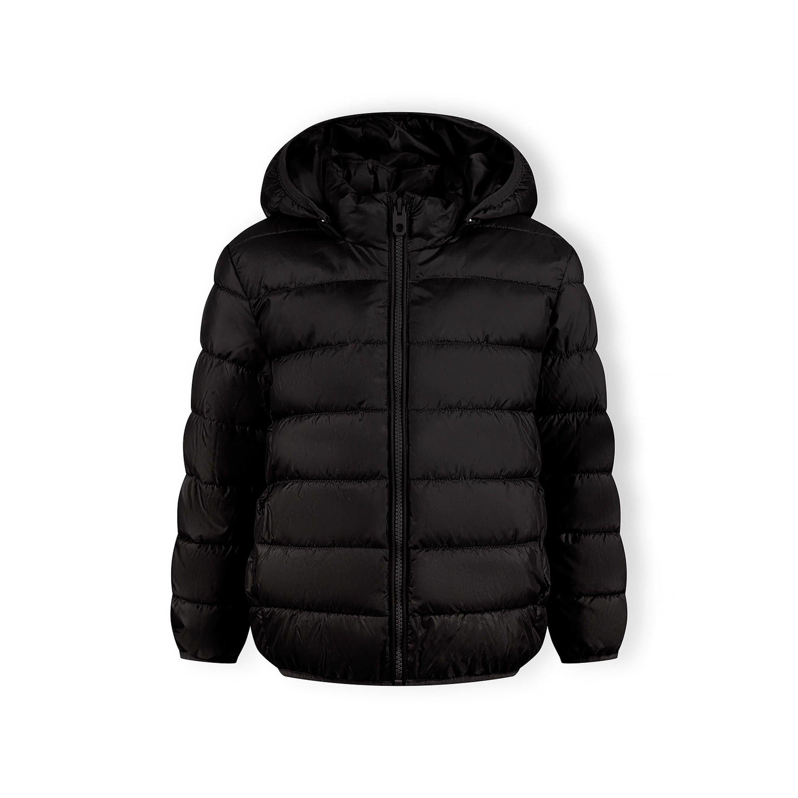 Close-up detail of black padded jacket showing quilted texture and circular Minoti logo patch on sleeve