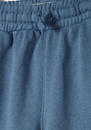 Elasticated drawstring waistband of blue joggers from boys crew neck sweatshirt and joggers set drawstring blue 1-8y. 