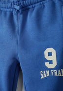 Boys joggers in cobalt blue with printed '9' and 'SAN FRAN' details, soft cotton blend, suitable for ages 1-8 years.