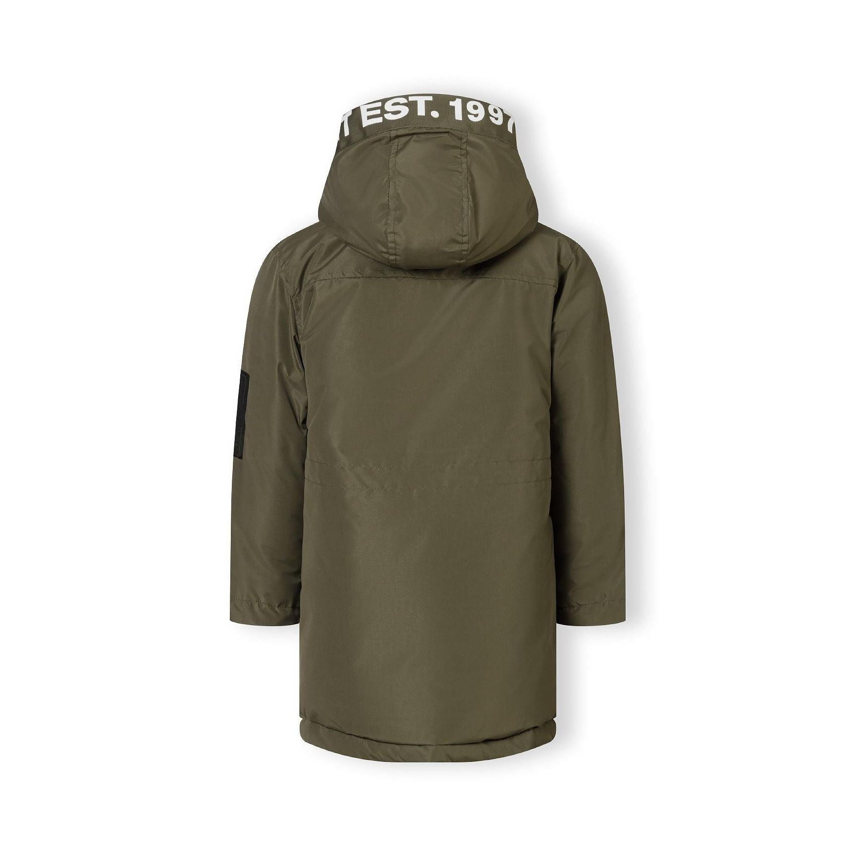 Close-up detail of khaki jacket back showing EST. 1997 white text print across hood area