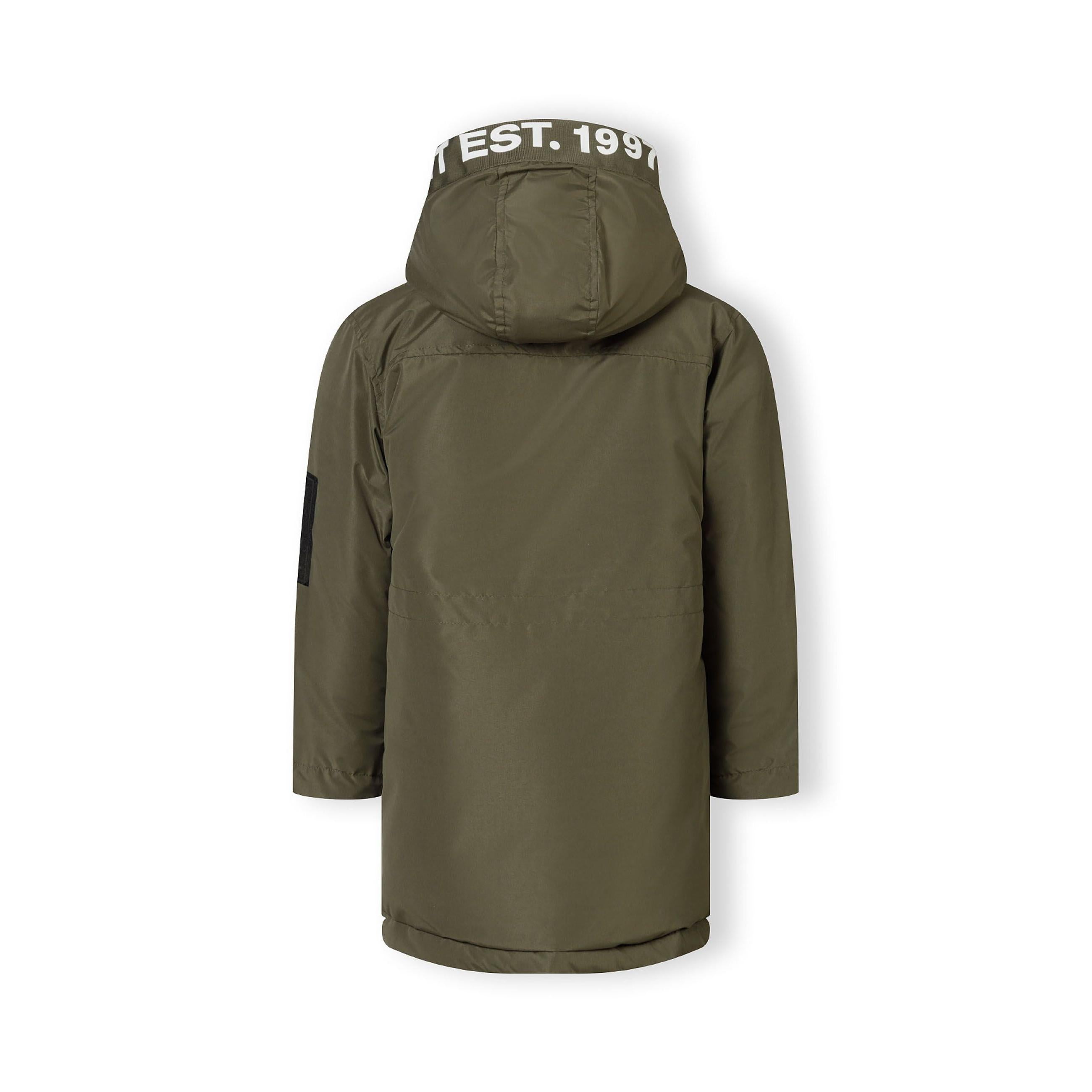 Close-up detail of khaki jacket back showing EST. 1997 white text print across hood area