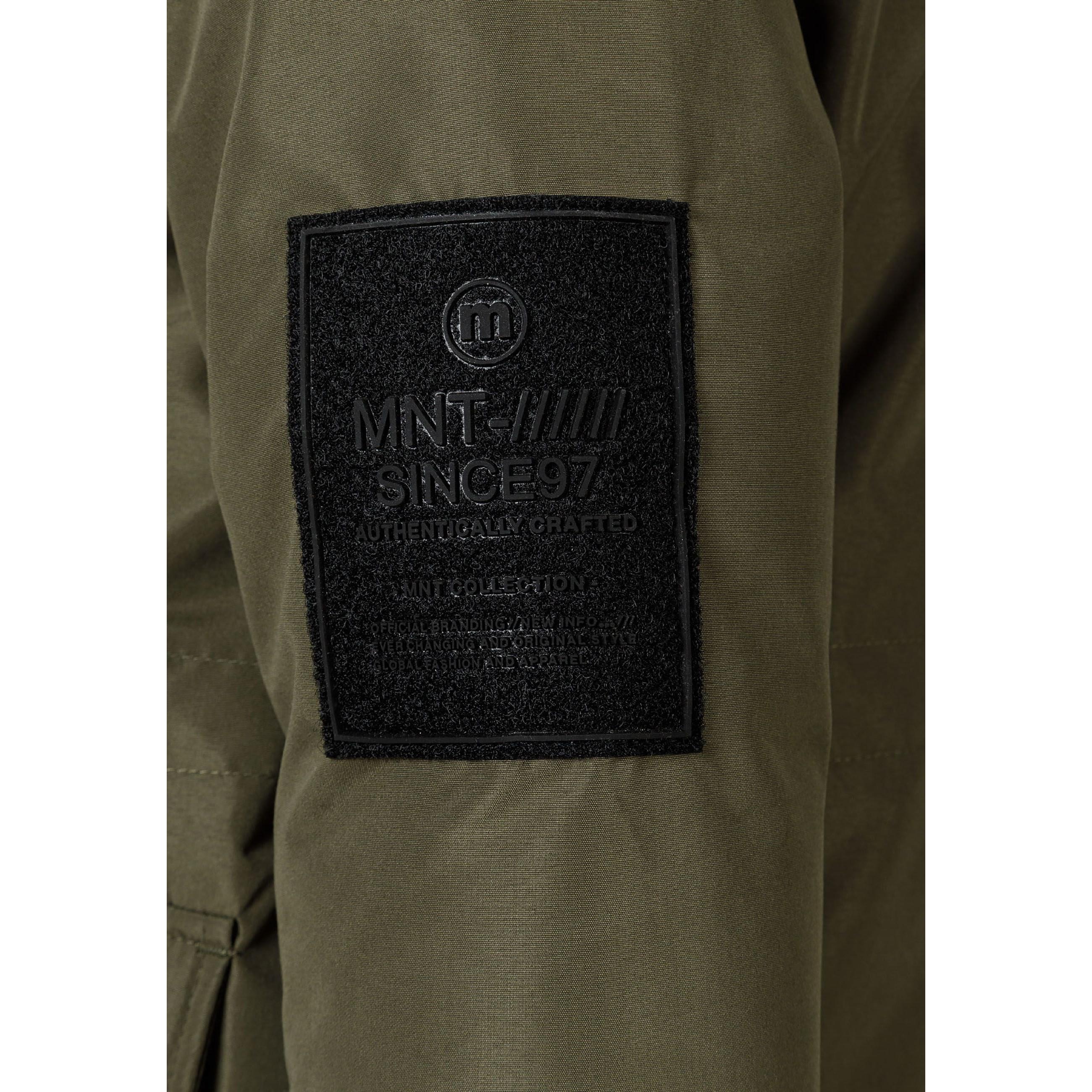 Close-up detail of khaki jacket back showing EST. 1997 white text print across hood area