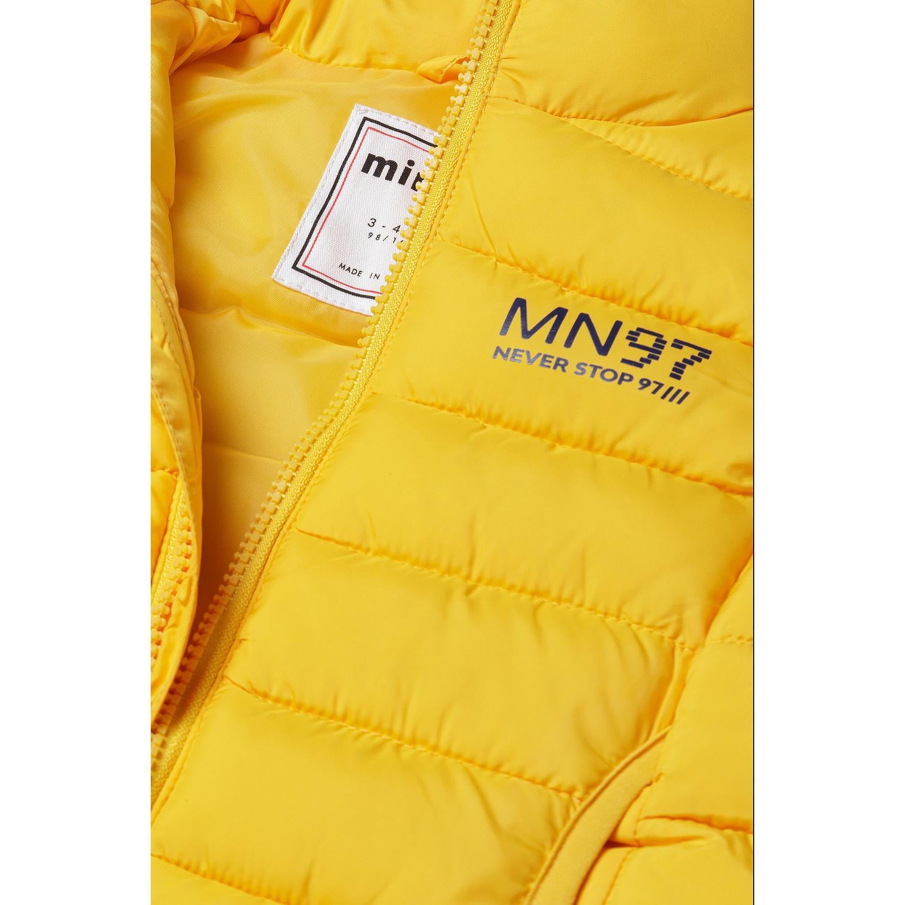 Close-up detail of yellow padded gilet showing zip opening, Minoti label and MN97 Never Stop branding print
