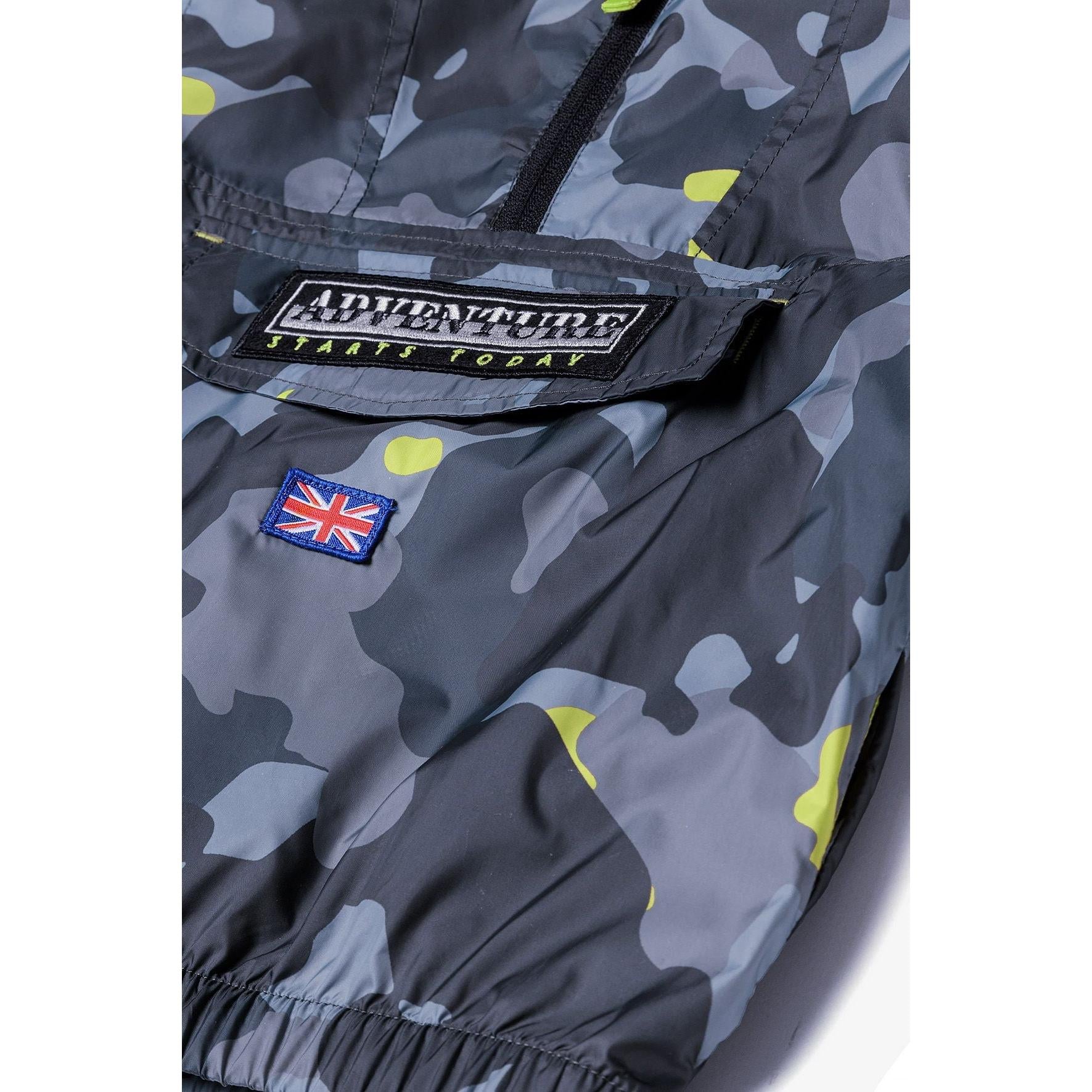 Close-up detail of unzipped windbreaker showing bright yellow mesh lining and Minoti brand label inside jacket