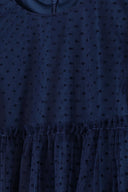 Navy blue polka dot girls party dress with sheer mesh and ruffled hem