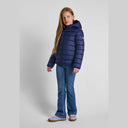 Girl in navy quilted jacket with detachable hood, high collar, and zip closure.