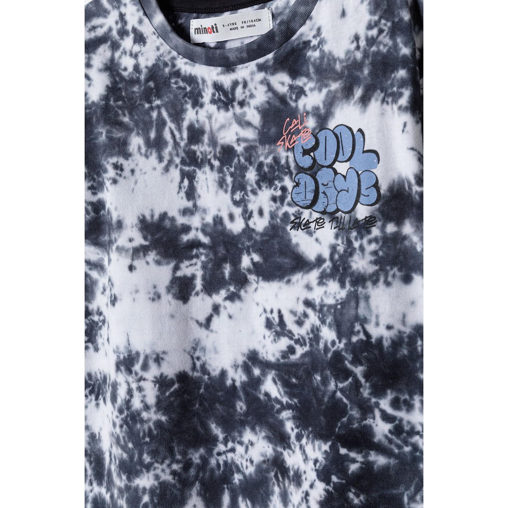 Close-up detail of front chest area showing 'COOL DUDE' graphic print with Minoti label visible at neck, tie dye pattern background